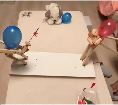 Balloon-headed puppets dueling on a tabletop